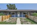 Ranch style home with gray siding and wooden fence at 6335 Martin Luther King Jr Blvd, Denver, CO 80207