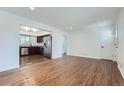 Living room features hardwood floors and an open kitchen at 6335 Martin Luther King Jr Blvd, Denver, CO 80207