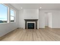 Living room featuring hardwood floors and a fireplace at 9314 Quartz St, Arvada, CO 80007