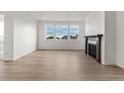 Bright living room with hardwood floors, fireplace, and large windows at 9314 Quartz St, Arvada, CO 80007