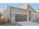 Modern home's exterior boasts stone accents and a two-car garage at 5959 S Platte Canyon Dr, Littleton, CO 80123