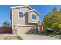 Two-story home with beige siding, attached garage, and landscaping at 22281 E Navarro Pl, Aurora, CO 80018