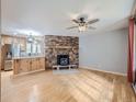 Living room features a stone fireplace and hardwood floors at 73 Blue Spruce Dr, Evergreen, CO 80439