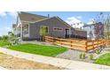 Landscaped backyard with a wooden fence at 5663 W 142 Ave, Broomfield, CO 80020