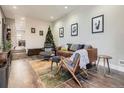 Spacious living room featuring a stylish leather couch and mid-century modern accents at 1056 S Harrison St, Denver, CO 80209