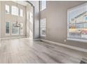 Spacious dining area with large windows and hardwood floors at 10586 W Maplewood Dr, Littleton, CO 80127