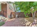 Stone patio with seating area and artistic fence at 1048 Garfield St, Denver, CO 80206