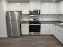 Modern kitchen featuring stainless steel appliances and white shaker cabinets at 3728 N Gaylord St, Denver, CO 80205