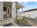 Inviting front porch with stone pathway, and landscaping at 540 Scrubjay Trl, Castle Rock, CO 80104