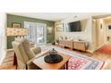 Living room with sliding glass doors, large TV, and comfy seating at 309 E Highline Cir # 101, Centennial, CO 80122