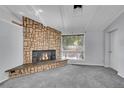 Stone fireplace with a raised hearth in the living room at 106 Locust Ave, Lochbuie, CO 80603