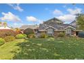 Two-story house with brick exterior and landscaping at 6030 Fox Hill Dr, Longmont, CO 80504