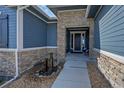 Front entrance with stone accents and water feature at 18352 W 95Th Pl, Arvada, CO 80007