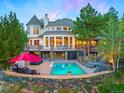 Stunning home exterior with stone accents and pool at 29115 Summit Ranch Dr, Golden, CO 80401