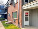 Brick building with a for sale sign on the door at 7050 W Cedar Ave # 108, Lakewood, CO 80226