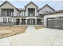 Two-story home with stone accents and modern garage doors at 12750 Imboden Rd, Hudson, CO 80642