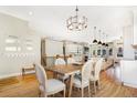 Bright dining room features a rustic farmhouse table and hardwood floors at 15932 Deer Ridge Dr, Morrison, CO 80465