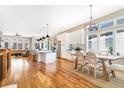 Open concept kitchen with island, hardwood floors, and white cabinets at 15932 Deer Ridge Dr, Morrison, CO 80465