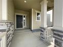 Covered porch entrance with stone accents at 12927 Range St, Firestone, CO 80107