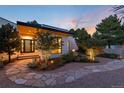 Modern home's front yard with a stone pathway, landscaping, and outdoor lighting at 3823 Castle Butte, Castle Rock, CO 80109