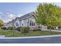 Two-story home with light gray siding and stone accents at 11024 W Hinsdale Dr, Littleton, CO 80127