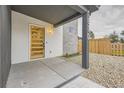 Modern front entrance with a light-colored wood door at 1670 Simms St, Lakewood, CO 80215