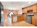 Kitchen with light wood cabinets and hardwood floors at 6273 Sparrow Cir, Firestone, CO 80504