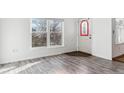 Entryway with gray wood-look flooring, a window, and a door with decorative glass at 1648 S Cole St # B7, Lakewood, CO 80228