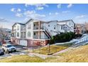 Exterior view of a multi-story condo building with balconies, garages, and landscaping at 1648 S Cole St # B7, Lakewood, CO 80228