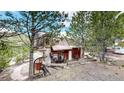 Rustic cabin with hot tub and surrounding trees at 131 Russel Gulch Rd, Central City, CO 80403