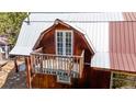 Upper-level balcony with French doors and wooden railing at 131 Russel Gulch Rd, Central City, CO 80403