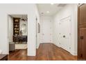 Bright hallway with hardwood floors and access to an office and closets at 100 Detroit St # 406, Denver, CO 80206