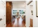 Elegant hallway with hardwood floors offering a view into the living and dining areas at 100 Detroit St # 406, Denver, CO 80206