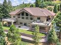 Two-story home with large deck, offering mountain views at 7131 Fox Cir, Larkspur, CO 80118