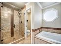 Primary bathroom with walk-in shower and soaking tub at 2575 S Independence Ct, Lakewood, CO 80227