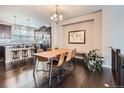 Bright dining area with hardwood floors, a rustic wood table, and leather chairs at 1854 Jules Ln, Louisville, CO 80027