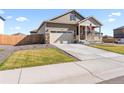 Beige ranch home with a two-car garage at 13408 Wabash St, Thornton, CO 80602