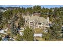Luxury home situated on a hillside with mountain views and mature trees at 1682 Montane E Dr, Golden, CO 80401