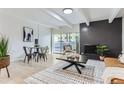 Open concept living room with dining area and fireplace at 555 E 10Th Ave # 3, Denver, CO 80203