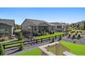 Landscaped backyard with a wooden fence, grass, and gravel at 22046 E Allenspark Pl, Aurora, CO 80016