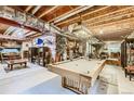 Finished basement featuring a pool table and entertainment area at 10091 Joplin St, Commerce City, CO 80022