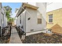 Side entrance with a walkway and black metal gate at 1431 Tamarac St, Denver, CO 80220