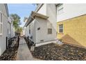 Side entrance with a walkway and black metal gate at 1431 Tamarac St, Denver, CO 80220