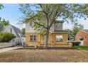 Two-story home with brick and stucco exterior, paved driveway at 1431 Tamarac St, Denver, CO 80220