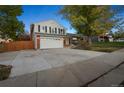 Two-story home with brick facade, attached garage, and mature trees at 3373 W 11Th Ave Dr, Broomfield, CO 80020