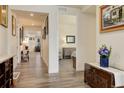 Long hallway with hardwood floors, offering views into living areas and bedrooms at 8901 S Ukraine Ct, Aurora, CO 80016