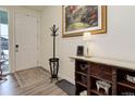 Bright and spacious entryway with hardwood floors, coat rack, and console table at 8901 S Ukraine Ct, Aurora, CO 80016