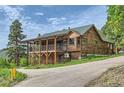 Mountain home with a large deck and attached garage; mountain setting at 6474 Lone Eagle Rd, Golden, CO 80403