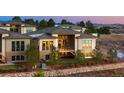 Contemporary home with a spacious deck and a stone retaining wall, offering a private backyard setting at 1192 Lost Elk Loop, Castle Rock, CO 80108