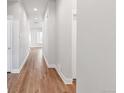 Bright hallway with light wood flooring and neutral walls at 21214 E 63Rd Dr, Aurora, CO 80019